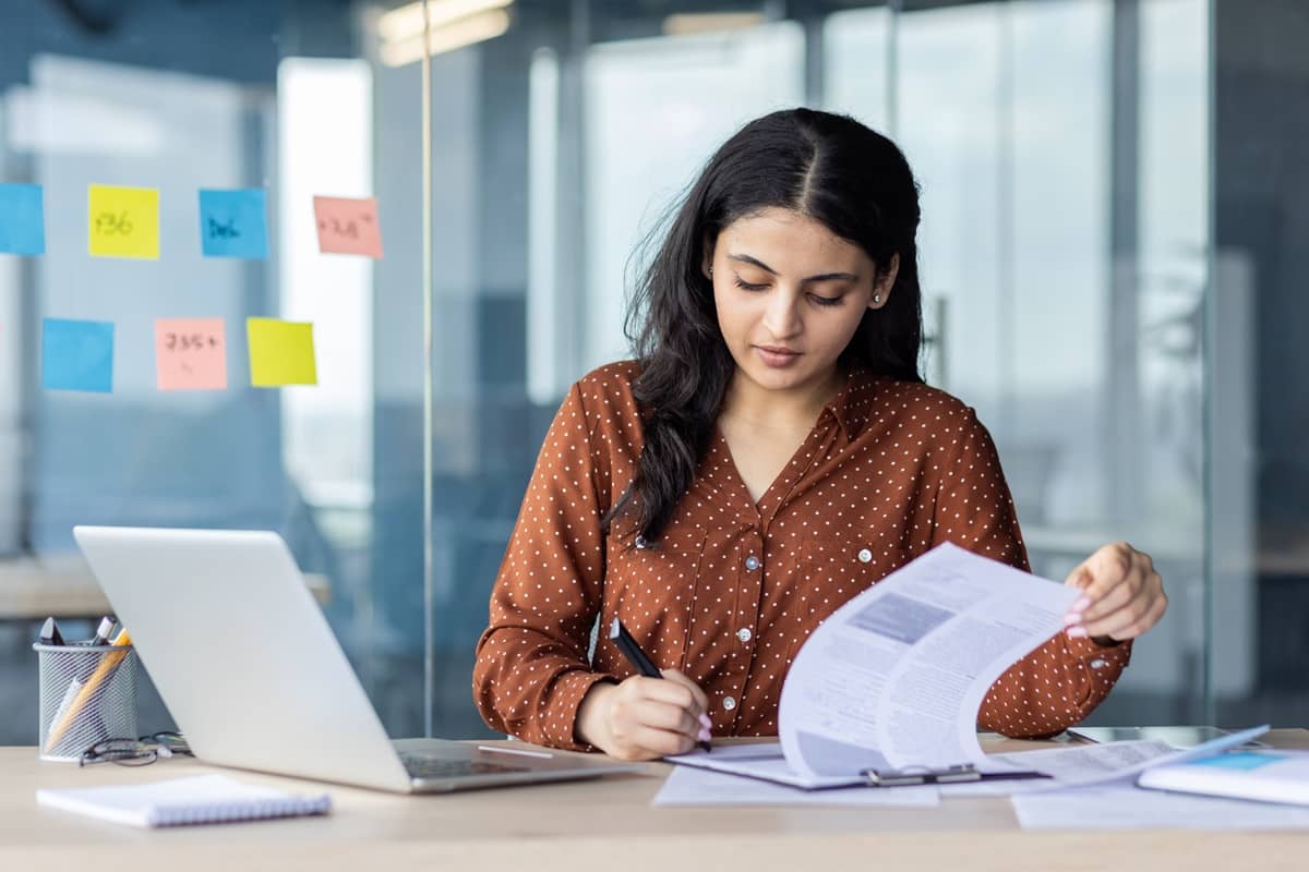 ऑस्ट्रेलियाई वीज़ा दस्तावेज़ भरती हुई युवा भारतीय महिला वकील