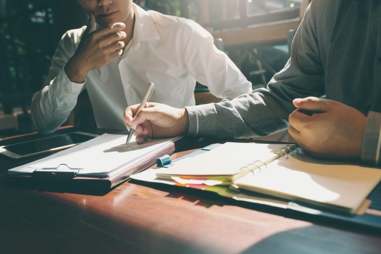 Person reviewing due diligence findings with a legal adviser in Australia.