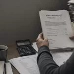 Featured image for How to Manage Property Division with Business Assets - Capture an intimate overtheshoulder shot of a perso